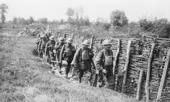 Irish Guards going up a communication trench. Image: John Warwick Brooke [Public domain]