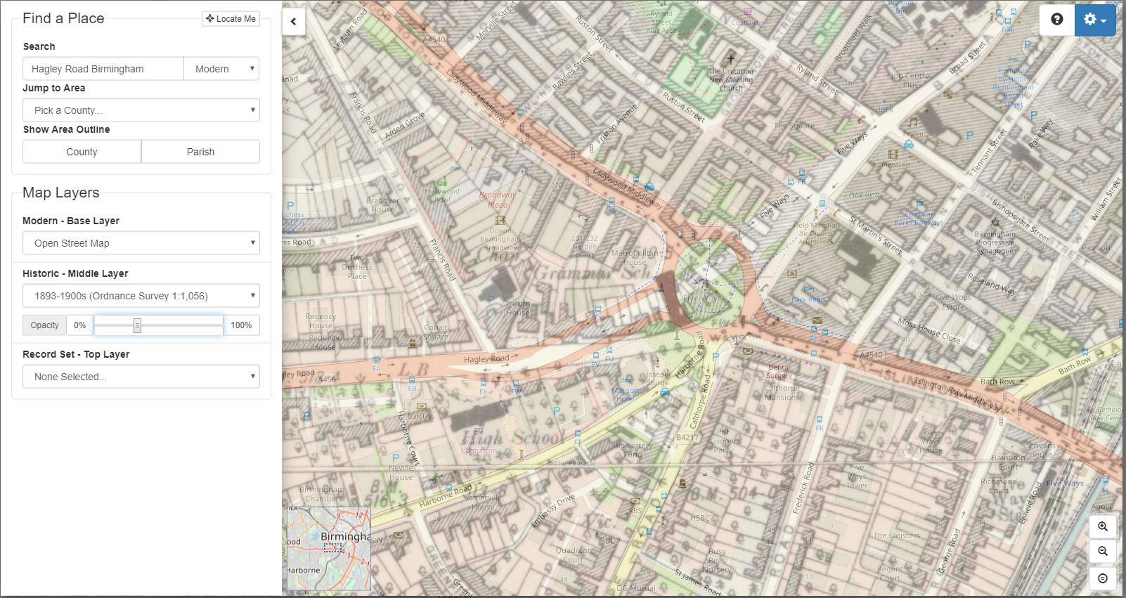 A modern street map faded in under the historic map layer reveals the footprint of the school beneath the new roundabout junction