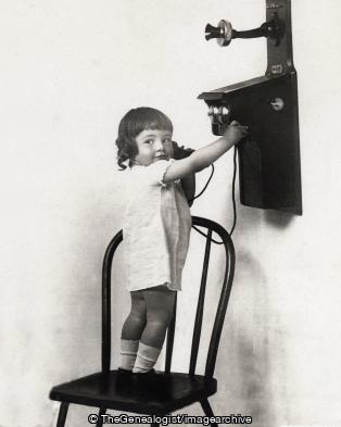 Toddler and old fashioned phone 1910 (1910, child, Telephone)
